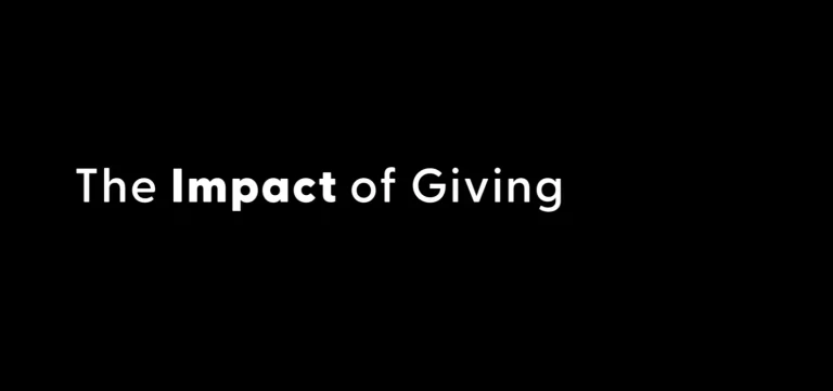 Black slide with white text reading “The Impact of Giving,” emphasizing women-led community impact.