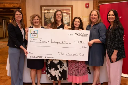 Group presenting a $7,500 grant check to the Junior League of Topeka, showcasing women’s philanthropy in Topeka.