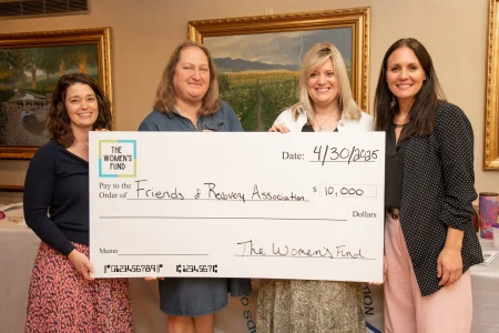 Four women presenting a $10,000 grant check to Friends of Recovery, illustrating women-led community impact.