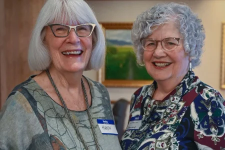 Two women smiling at a community gathering, representing women-led philanthropy Topeka KS.