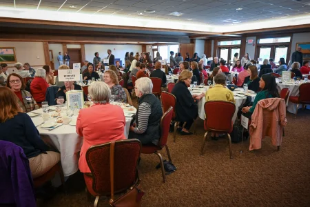 Banquet hall filled with attendees at a luncheon, highlighting a women’s collective giving group in Topeka.