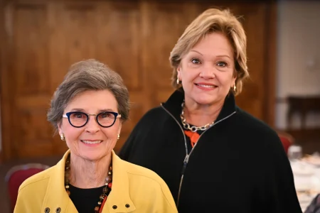 Two people standing together at a formal event, reflecting women-led community impact in Topeka.